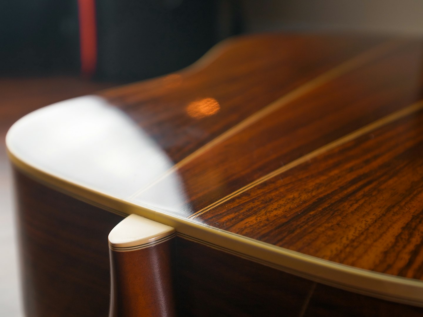 Acoustic guitar back showing the detailed wood grain and inlay.
